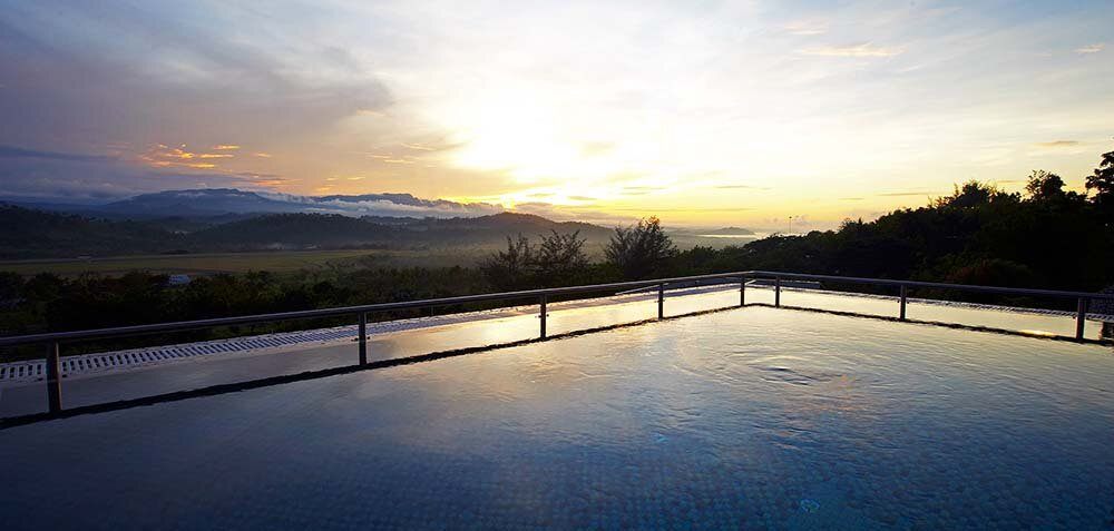 A pool at Airways Hotel at sunset, looking out over the hills