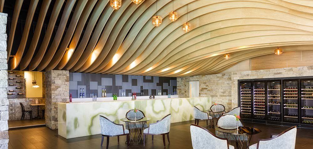 Vue Restaurant and Lounge Bar, with a curved timber-slat ceiling and white chairs