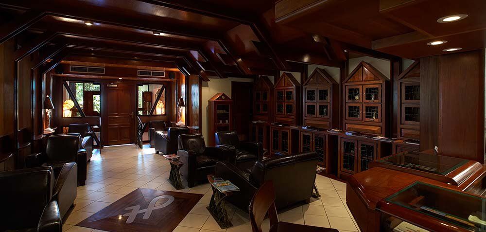 Leather armchairs and dark timber liqueur lockers in the Havanaba bar
