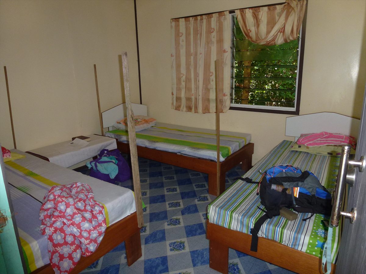 A simple bedroom with three single beds in the ranger station building