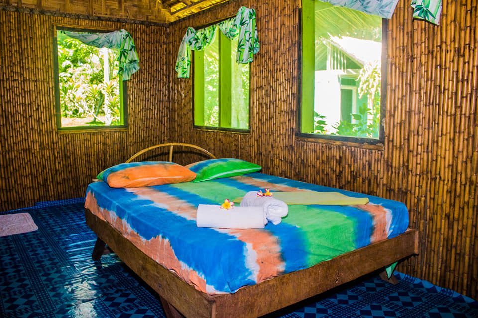 Inside a bungalow bedroom at B-17 Dive and Beach Bungalows