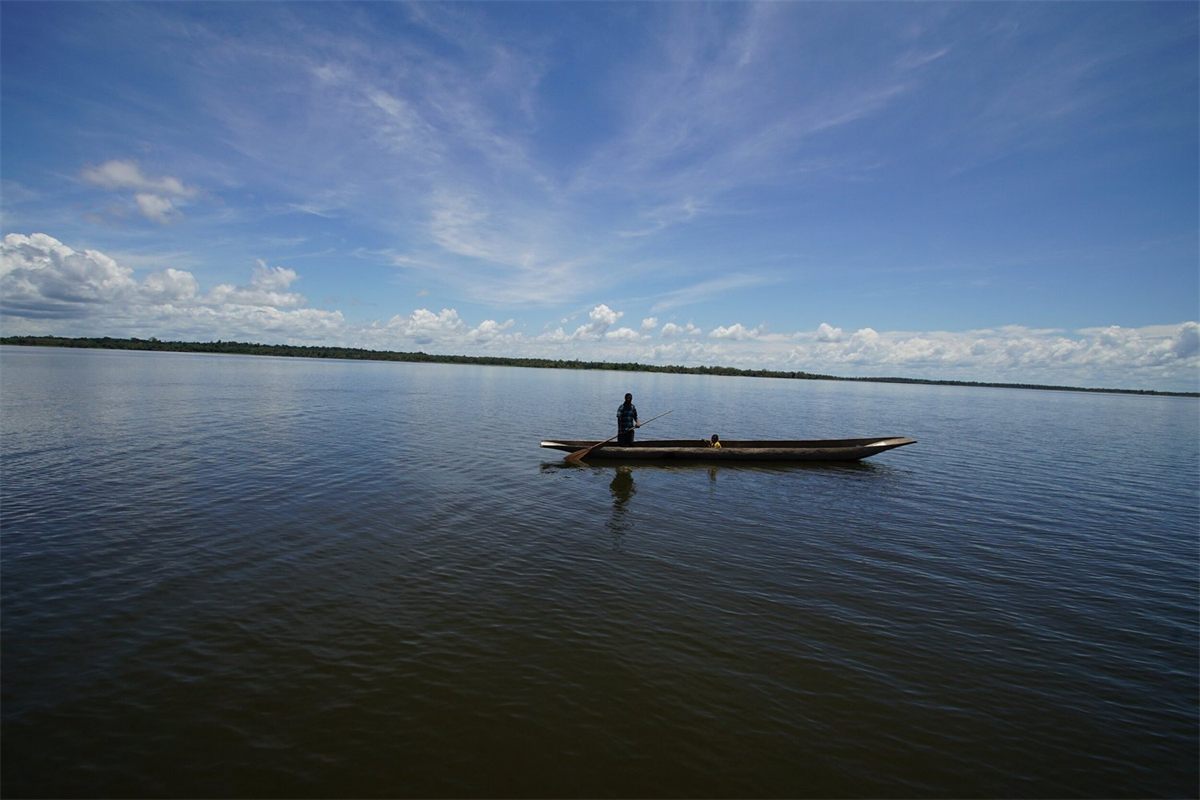 A dugout canoe on the still water of Lake Murray, Papua New Guinea