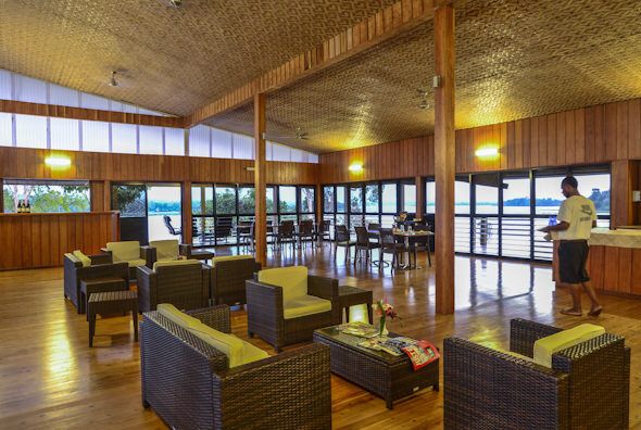 The lounge and dining room inside the main lodge, with windows looking out over the lake