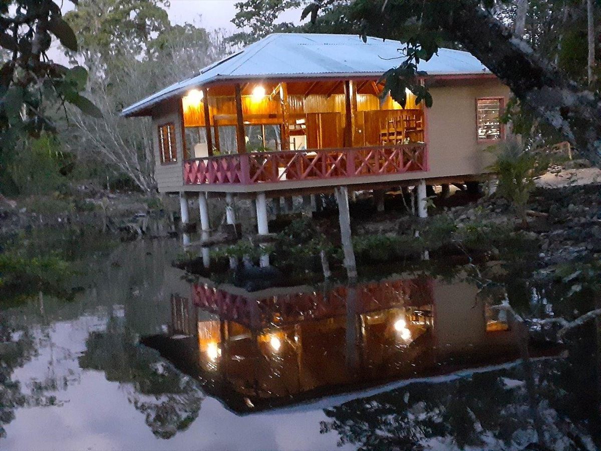 The Vinarpoha Restaurant lit up at dusk and reflected in the still water below