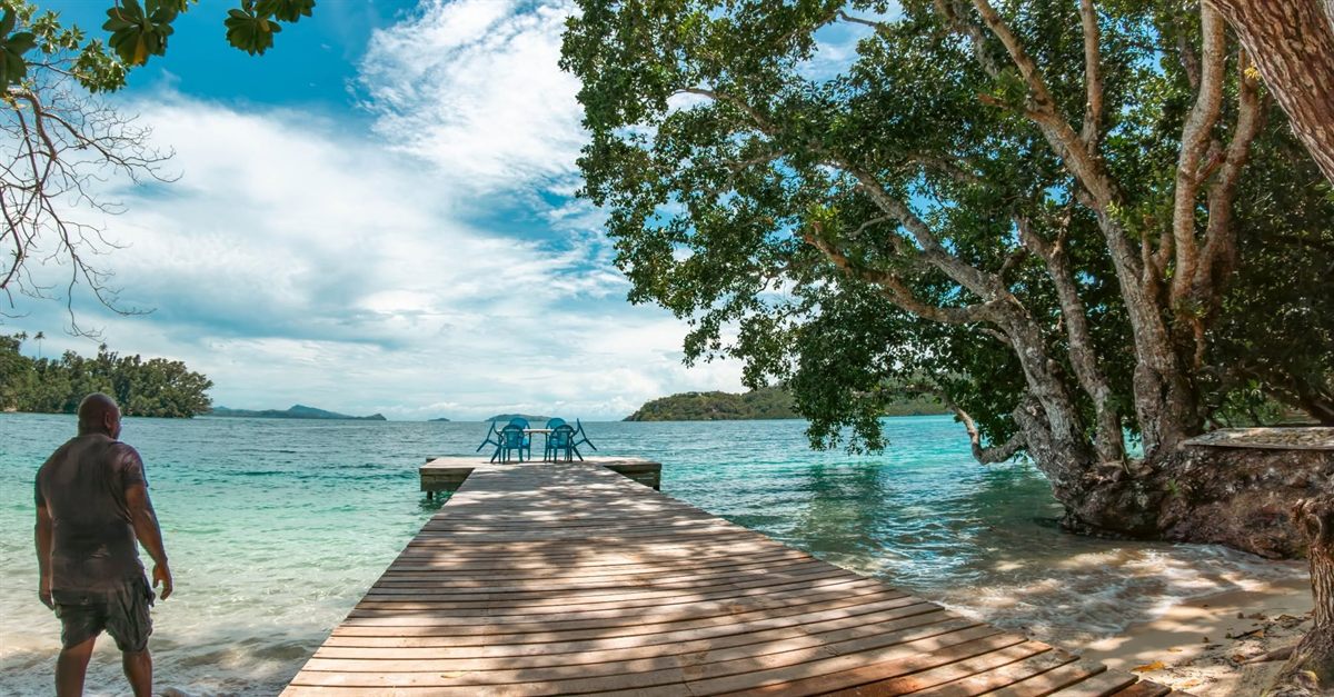 Nugu Beach Resort's jetty running out over clear turquoise water