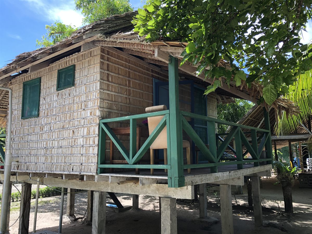 A raised bungalow with a verandah at Nugu Beach Resort