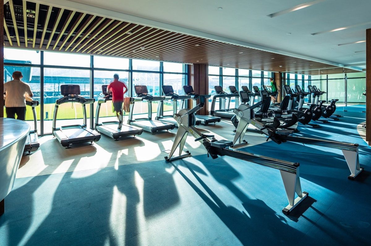 Treadmills and rowing machines in the Fitness Centre, beside a wall of windows