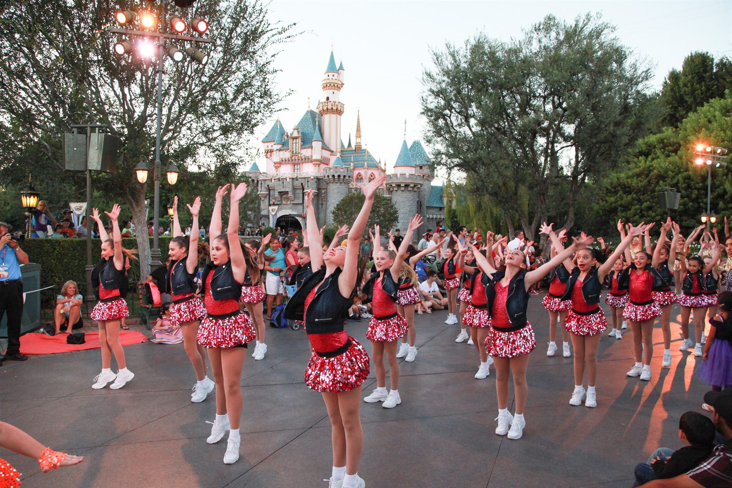 Go Tours dancers performing in front of Sleeping Beauty Castle at Disneyland