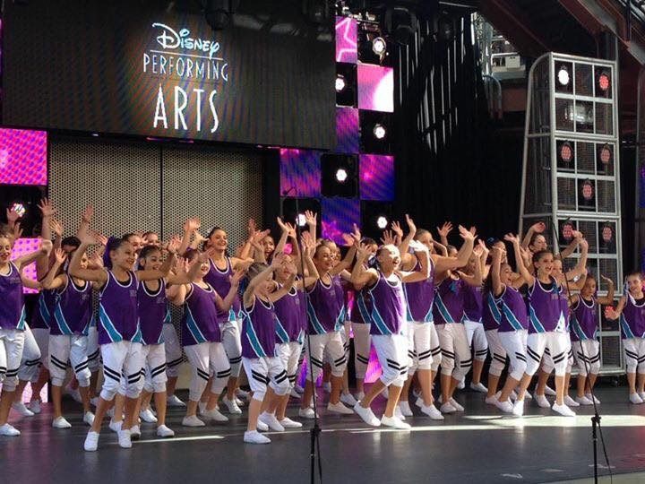 A large Go Tours dance group performing on the Disney Performing Arts stage